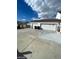 Three-car garage with concrete driveway at 1590 Mustang Dr, Henderson, NV 89002