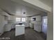 Modern kitchen featuring white shaker cabinets and an island at 1590 Mustang Dr, Henderson, NV 89002