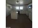 Modern kitchen with white cabinets, an island, and gray flooring at 1590 Mustang Dr, Henderson, NV 89002