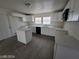 Modern kitchen with white cabinets, an island, and gray flooring at 1590 Mustang Dr, Henderson, NV 89002