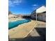 Inviting kidney-shaped pool with concrete decking at 1590 Mustang Dr, Henderson, NV 89002