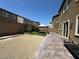 The backyard has artificial grass, gravel, and brick pavers at 181 Elexese Ct, Las Vegas, NV 89183