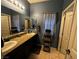 Bathroom featuring double sinks with granite countertop and linen storage at 181 Elexese Ct, Las Vegas, NV 89183