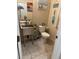 Cozy bathroom with pedestal sink, beach decor, and neutral wall and floor tiles at 181 Elexese Ct, Las Vegas, NV 89183