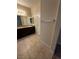 Bathroom featuring a double vanity, granite counters, and a large mirror at 181 Elexese Ct, Las Vegas, NV 89183