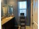 A bathroom with a granite countertop, a mirror, and blue walls at 181 Elexese Ct, Las Vegas, NV 89183
