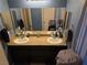 Bathroom features double sinks with granite countertop and two mirrors at 181 Elexese Ct, Las Vegas, NV 89183