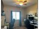 Bedroom with neutral walls, blue curtains, and a workstation including a chair and electronic monitor at 181 Elexese Ct, Las Vegas, NV 89183