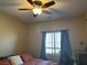 Bedroom featuring a ceiling fan, window, bed, and desk at 181 Elexese Ct, Las Vegas, NV 89183