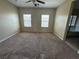Bedroom with neutral carpet, large windows and an adjoining bath with separate shower and tub at 181 Elexese Ct, Las Vegas, NV 89183