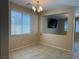 Dining area featuring tiled floors, a modern chandelier, and natural lighting at 181 Elexese Ct, Las Vegas, NV 89183