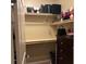 A walk-in closet with empty shelves and a dark wood dresser at 181 Elexese Ct, Las Vegas, NV 89183