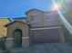 Two-story house with a brown brick facade, a large garage, and a paved driveway at 181 Elexese Ct, Las Vegas, NV 89183