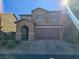 Charming two-story home featuring a desert landscape, attached two-car garage, and covered entryway at 181 Elexese Ct, Las Vegas, NV 89183