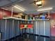Organized garage with overhead storage and built-in cabinets for tools and equipment at 181 Elexese Ct, Las Vegas, NV 89183