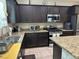 Modern kitchen features granite countertops, stainless steel appliances, and ample cabinet space at 181 Elexese Ct, Las Vegas, NV 89183