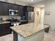Stylish kitchen features granite counters, stainless steel appliances, and an island with bar seating at 181 Elexese Ct, Las Vegas, NV 89183