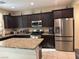 The kitchen features a large island, granite countertops, and stainless steel appliances at 181 Elexese Ct, Las Vegas, NV 89183