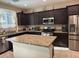 Modern kitchen features granite countertops, stainless steel appliances, and ample cabinet space at 181 Elexese Ct, Las Vegas, NV 89183