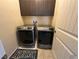 Laundry room with front-load washer and dryer, plus overhead storage at 181 Elexese Ct, Las Vegas, NV 89183