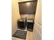 Laundry room with front loading washer and dryer, upper cabinets and tile flooring at 181 Elexese Ct, Las Vegas, NV 89183