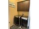 Laundry room with dark cabinets, a sign, a washer, and a dryer at 181 Elexese Ct, Las Vegas, NV 89183