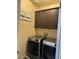 Laundry room with dark cabinets, a sign, a washer, and a dryer at 181 Elexese Ct, Las Vegas, NV 89183