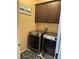 Laundry room with dark cabinets, a sign, a washer, and a dryer at 181 Elexese Ct, Las Vegas, NV 89183