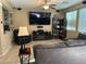 Spacious living room with large TV, built in shelving and ceiling fan at 181 Elexese Ct, Las Vegas, NV 89183