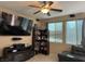 Inviting living room features a ceiling fan, entertainment center and built in bookcase at 181 Elexese Ct, Las Vegas, NV 89183