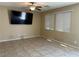 Comfortable living room with a large TV, tile floors, and bright windows at 181 Elexese Ct, Las Vegas, NV 89183