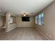 Bright living room with a ceiling fan, large TV, and window blinds at 181 Elexese Ct, Las Vegas, NV 89183