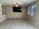Well-lit living room features tile flooring and a wall-mounted television at 181 Elexese Ct, Las Vegas, NV 89183