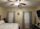 The main bedroom features neutral walls, large windows, and soft carpeting at 181 Elexese Ct, Las Vegas, NV 89183