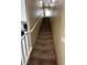 Carpeted staircase leading to the upper level, bathed in natural light from a window at the top at 181 Elexese Ct, Las Vegas, NV 89183