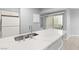 Kitchen island with quartz countertop and stainless steel sink at 2251 Wigwam Pkwy # 211, Henderson, NV 89074