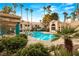 Community pool with surrounding lounge chairs at 2251 Wigwam Pkwy # 211, Henderson, NV 89074