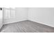 Bright bedroom with gray wood-look floors and white shutters at 2251 Wigwam Pkwy # 218, Henderson, NV 89074