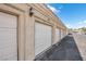 Row of white garage doors in a well-maintained parking area at 2251 Wigwam Pkwy # 218, Henderson, NV 89074