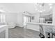 Open concept living and dining area with gray floors and modern light fixture at 2251 Wigwam Pkwy # 218, Henderson, NV 89074
