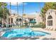 Community pool with lounge chairs and surrounding trees at 2251 Wigwam Pkwy # 218, Henderson, NV 89074