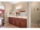 Double vanity bathroom with dark wood cabinets and tile flooring at 2520 Links Dr, Laughlin, NV 89029