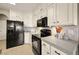 Modern kitchen with white cabinets and black appliances at 2520 Links Dr, Laughlin, NV 89029