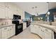 Kitchen with white cabinets, granite counters, and black appliances at 2520 Links Dr, Laughlin, NV 89029