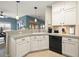 Modern kitchen with white cabinets, granite counters and black appliances at 2520 Links Dr, Laughlin, NV 89029