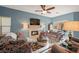 Living room with fireplace, comfortable seating and a view of the backyard at 2520 Links Dr, Laughlin, NV 89029