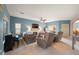 Bright living room with hardwood floors, comfy seating and a piano at 2520 Links Dr, Laughlin, NV 89029