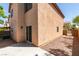 Backyard with a cemented patio, siding, and gravel with a brick wall at 3396 Villa Fiori Ave, Las Vegas, NV 89141