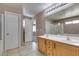 Primary bathroom with double sink vanity, tile floor, and separate water closet and shower at 3396 Villa Fiori Ave, Las Vegas, NV 89141