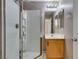 Bathroom with white tile shower, vanity with sink, and a framed mirror at 3396 Villa Fiori Ave, Las Vegas, NV 89141